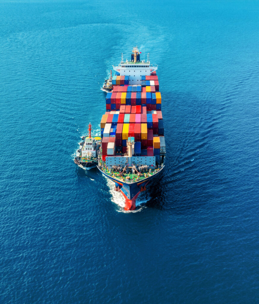 Aerial view of cargo ship with cargo container on sea.