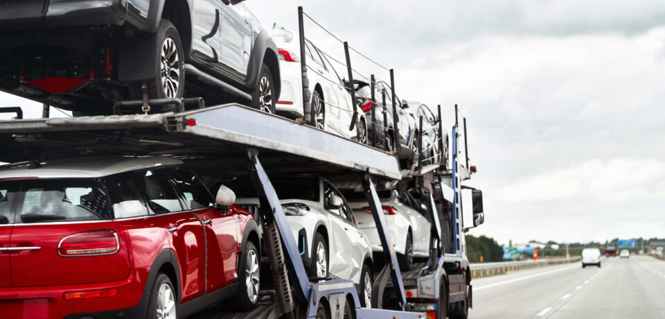 Tow truck at work. On an open road under the vast sky lies the silent tale of a car’s breakdown and the timely arrival of help.