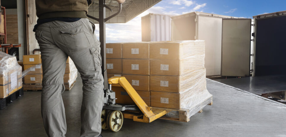 warehouse-worker-loading-package-boxes-into-shipping-container-truck